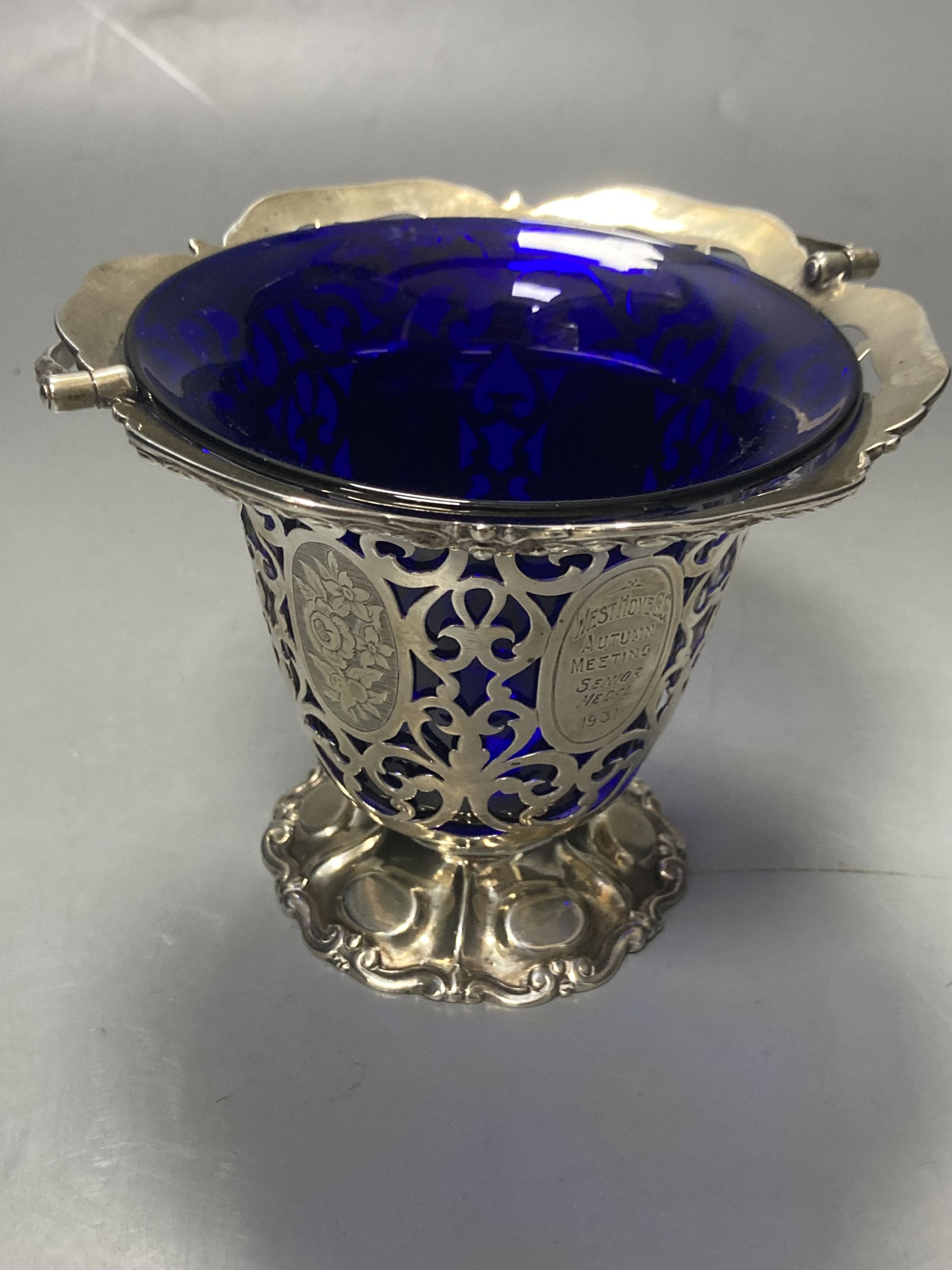 A Victorian pierced silver sugar basket, with blue glass liner and later engraved inscription, George Angell, London, 1854,